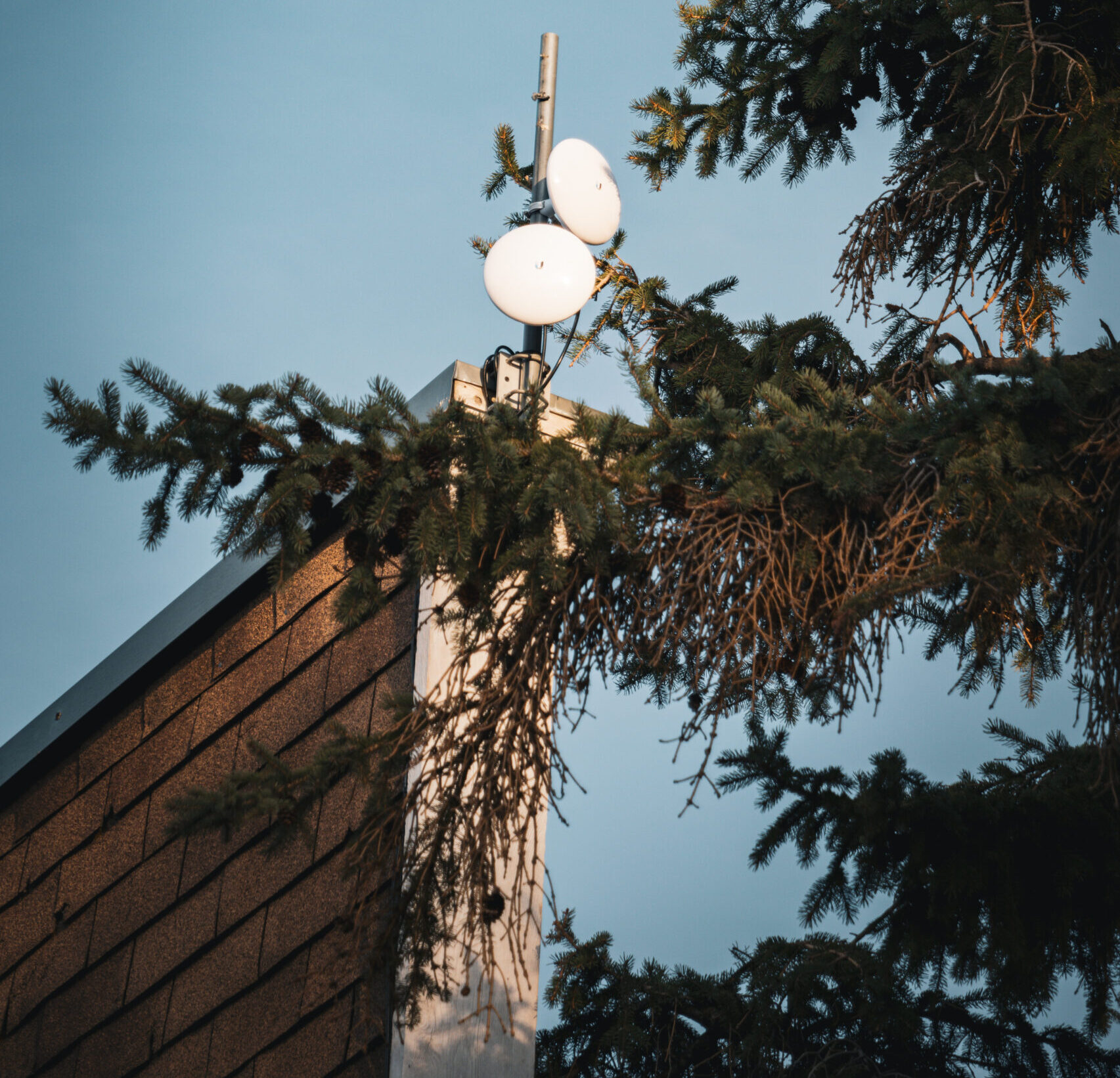 Two satellites atop a tall building